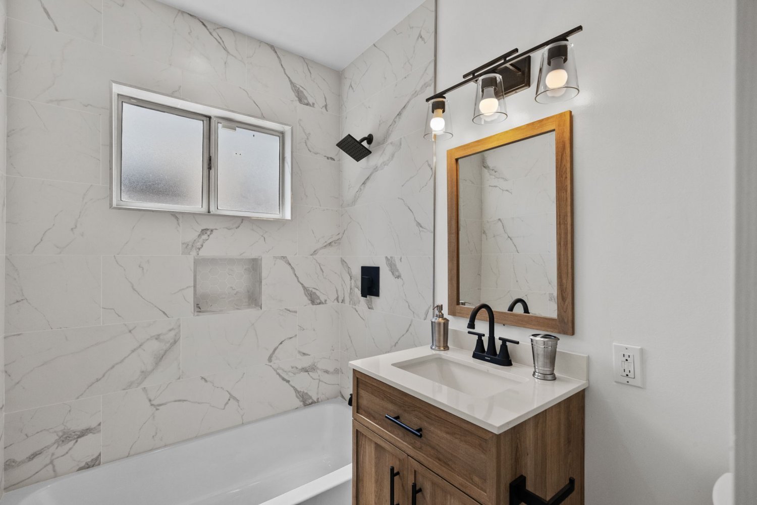 fully remodeled bathroom with white marble walls at 9651 oso ave