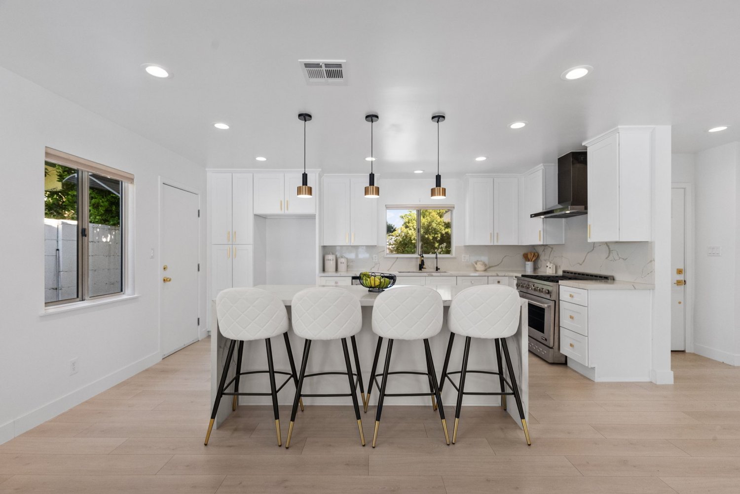 modern pretty all white kitchen in chatsworth california with marble countertops and gold finishes